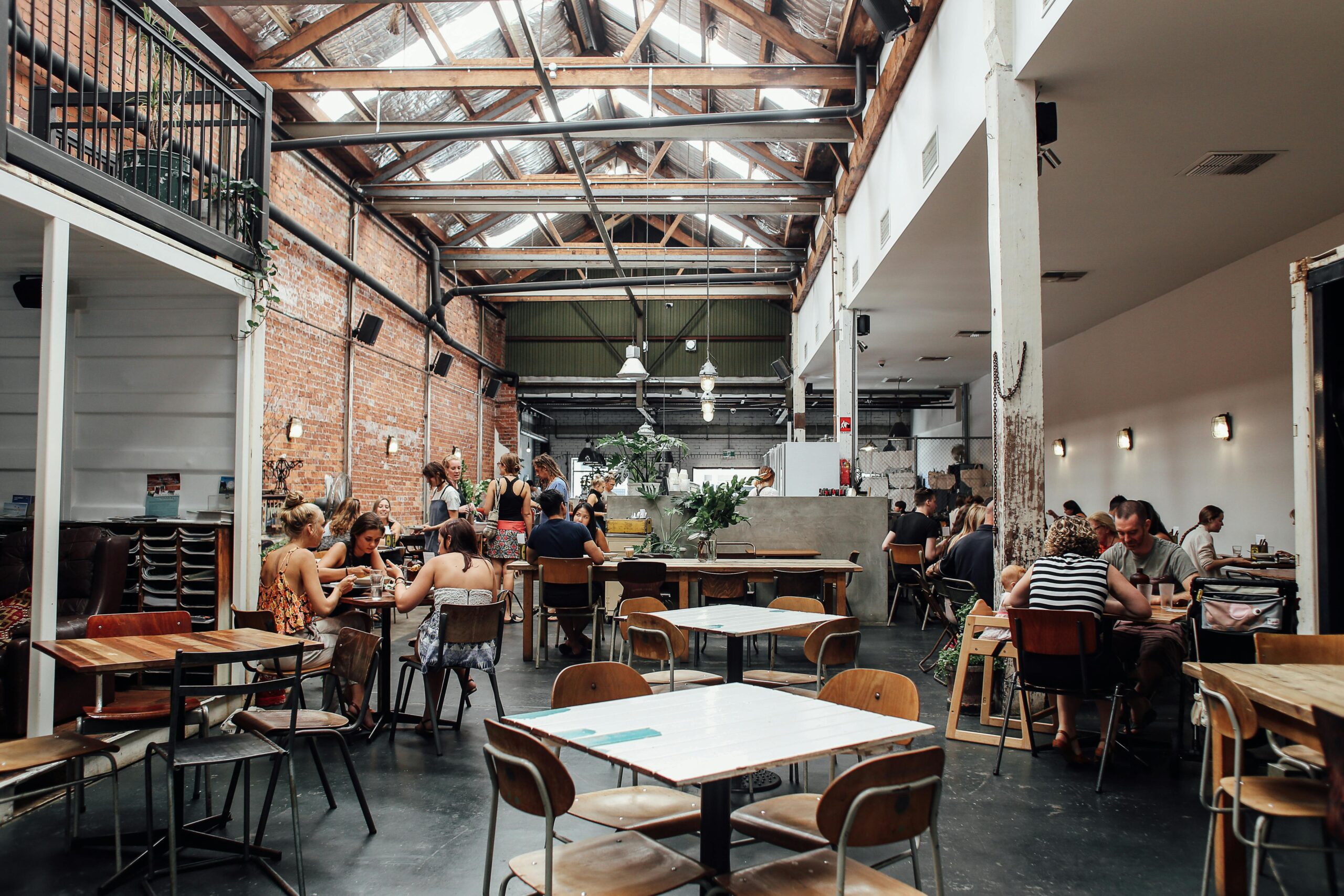People Sitting on Chairs Inside a Restaurant